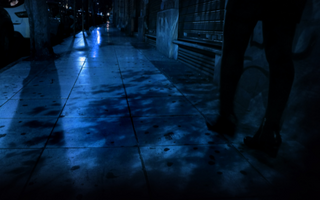 Girl walking alone in a dark street